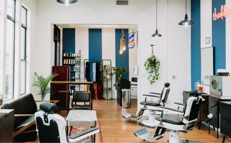 Bright and modern interior of Olde Soul Barbershop on South Lamar in Austin, TX, featuring classic barber chairs, stylish decor, and a welcoming lounge area. The vibrant space blends contemporary design with vintage barbering charm, offering premium haircuts and grooming services in South Austin.