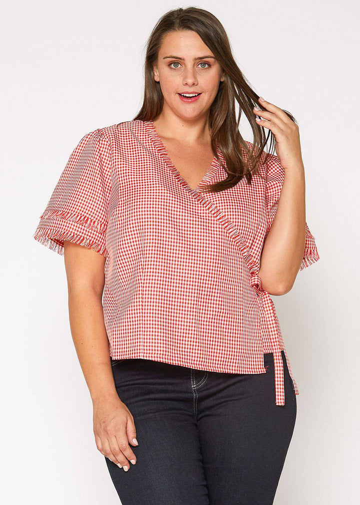 Plus Size Fringe Trim Gingham Wrap Blouse in Red Gingham by Shop at Konus