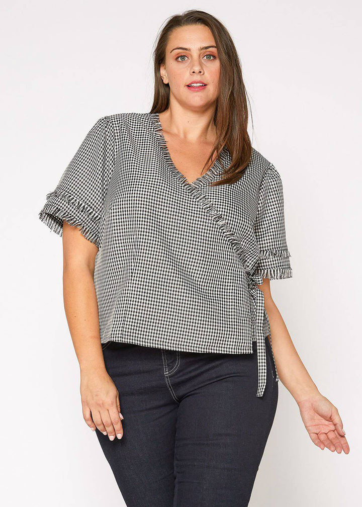 Plus Size Fringe Trim Gingham Wrap Blouse in Black Gingham by Shop at Konus